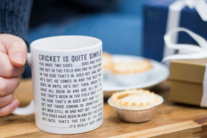 Funny cricket quote mug Christmas gift for Cricket Fans and Cricketers by Wit and Wisdom UK displayed with mince pies and christmas presents
