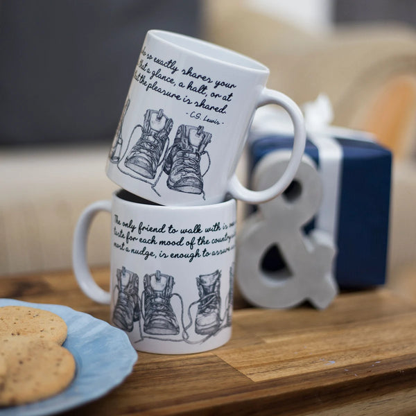 Two C.S. Lewis hiking friendship quote mugs by Wit and Wisdom stacked.
