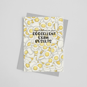 Exam congratulations card which reads congratulations on your eggcellent exam results with an illustration of lots of foam egg sweets in the background, designed by Wit and Wisdom UK.