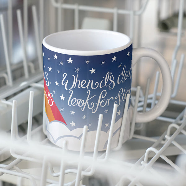 'Look for Rainbows' dishwasherproof printed  mug by Wit & Wisdom shown sitting in the dishwasher tray.