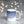 Single 11oz printed mug on a grey background blurry with fairylights. Design on mug is an illustration of a blue night sky with white stars and white colours and the words, When it's dark look for stars. The makers mark on the mug reads 'a mug full of Wit and Wisdom' in small type on the edge of the design.