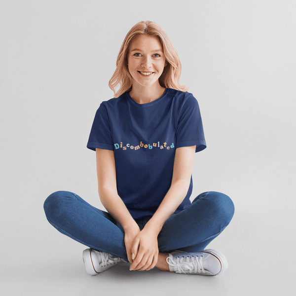 woman sitting on the floor wearing a discombobulated tshirt by wit and wisdom